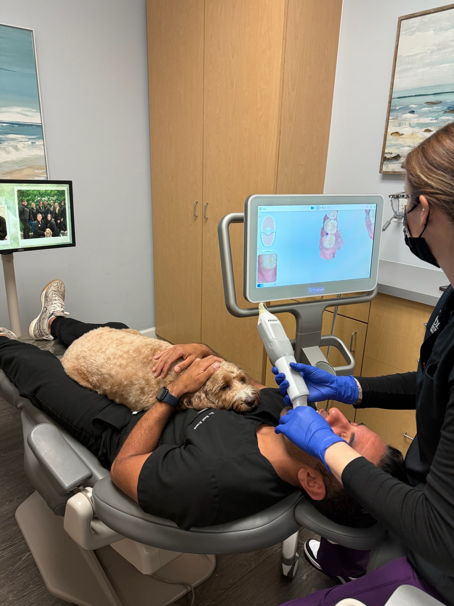 Emotional support office dog sitting with patient during orthodontic treatment